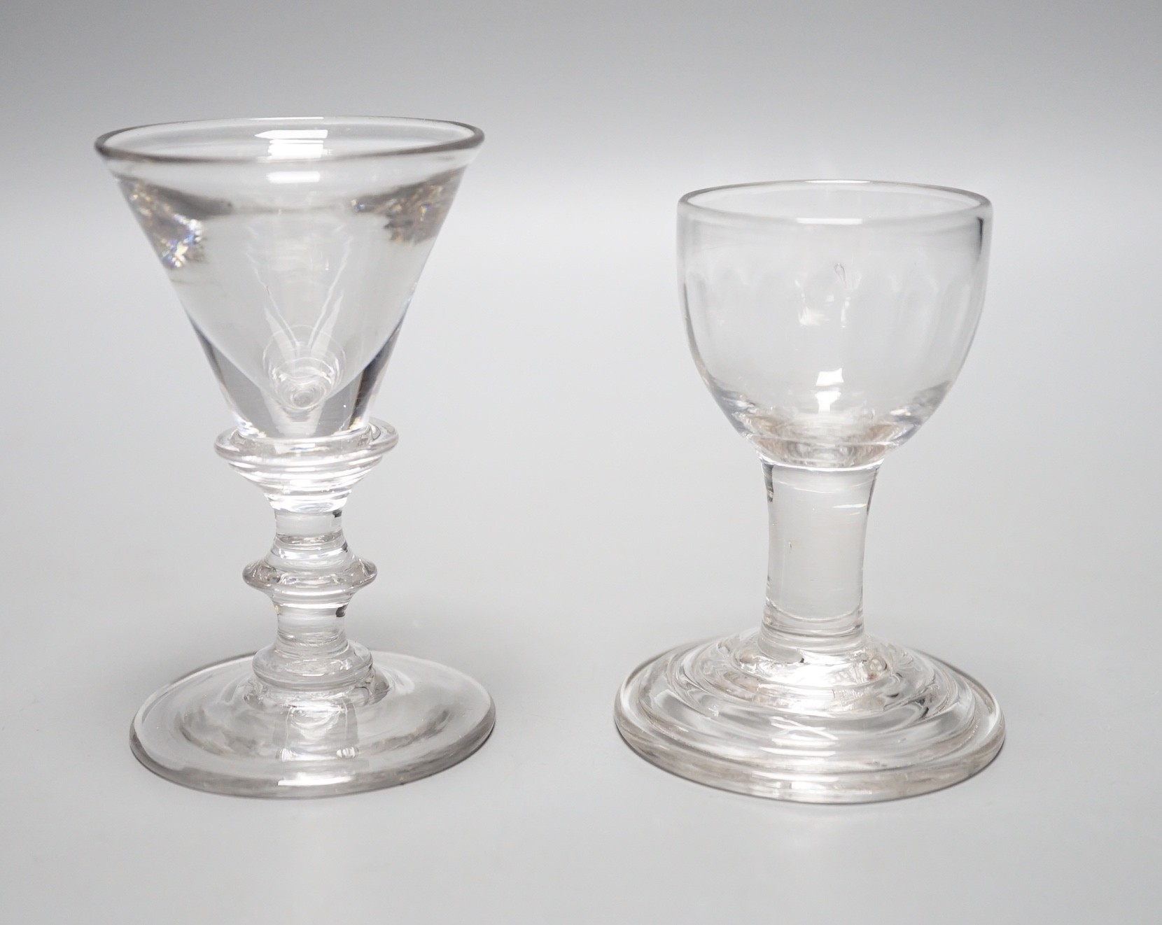 A George III dram glass, terraced foot and a similar deceptive glass, tallest 9.5cm